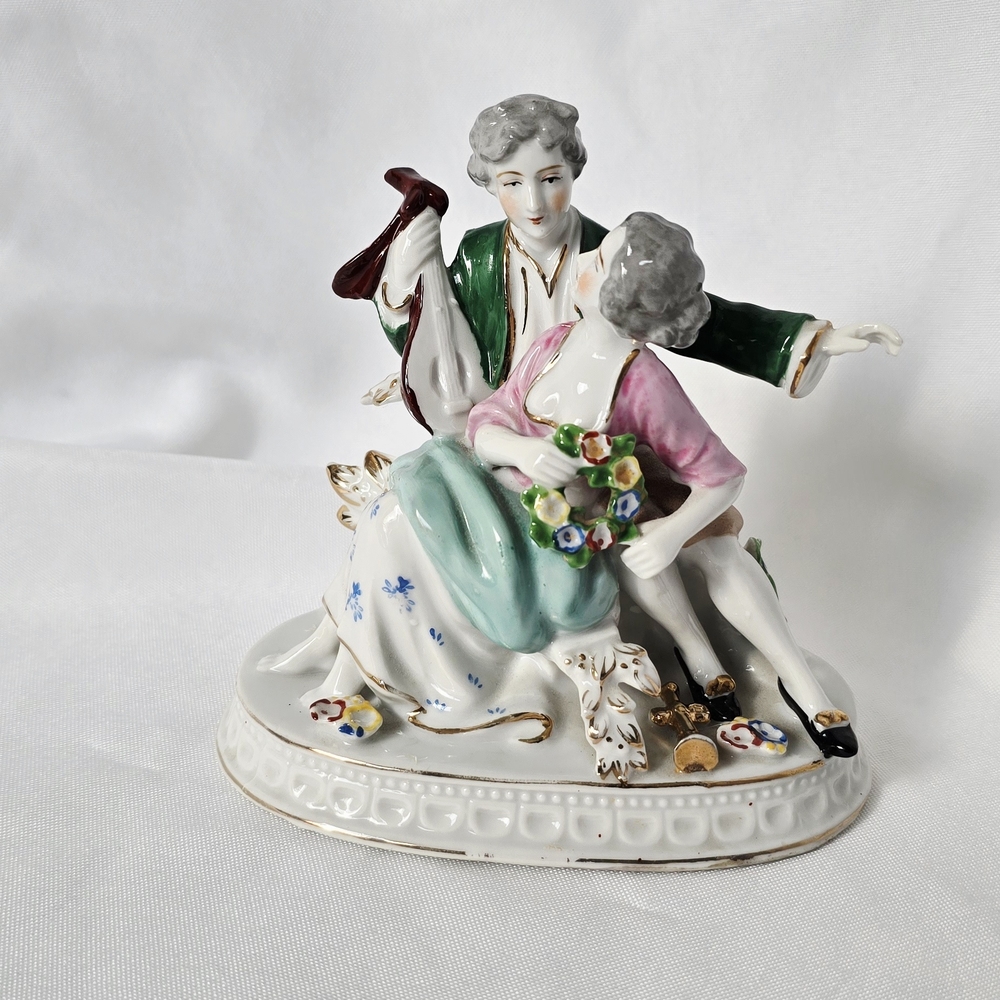 Elegant Porcelain Figurine with Green and Pink Accents